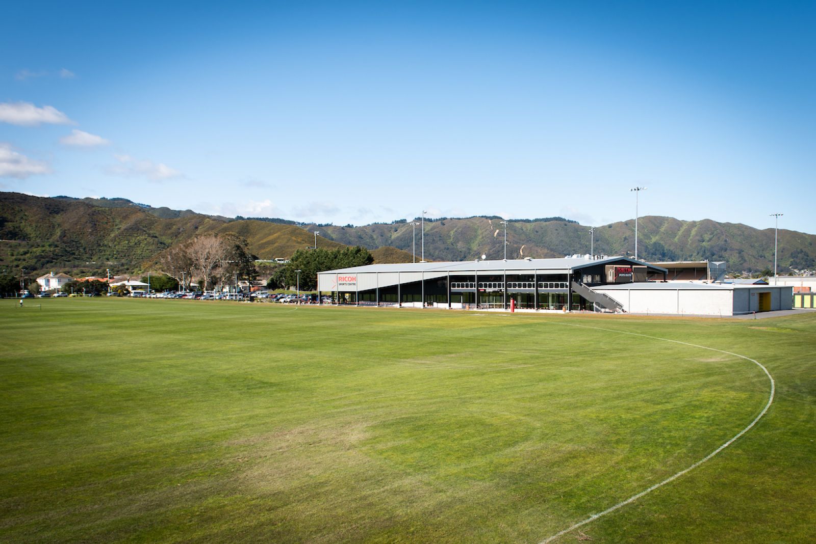 Picture of sports ground with building in the background banner image