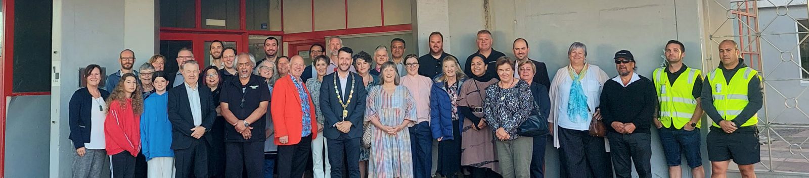 Group of people standing in front of the Naenae Community Centre banner image