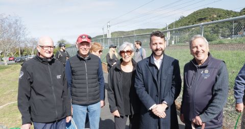 Five people standing on a shared pathway 