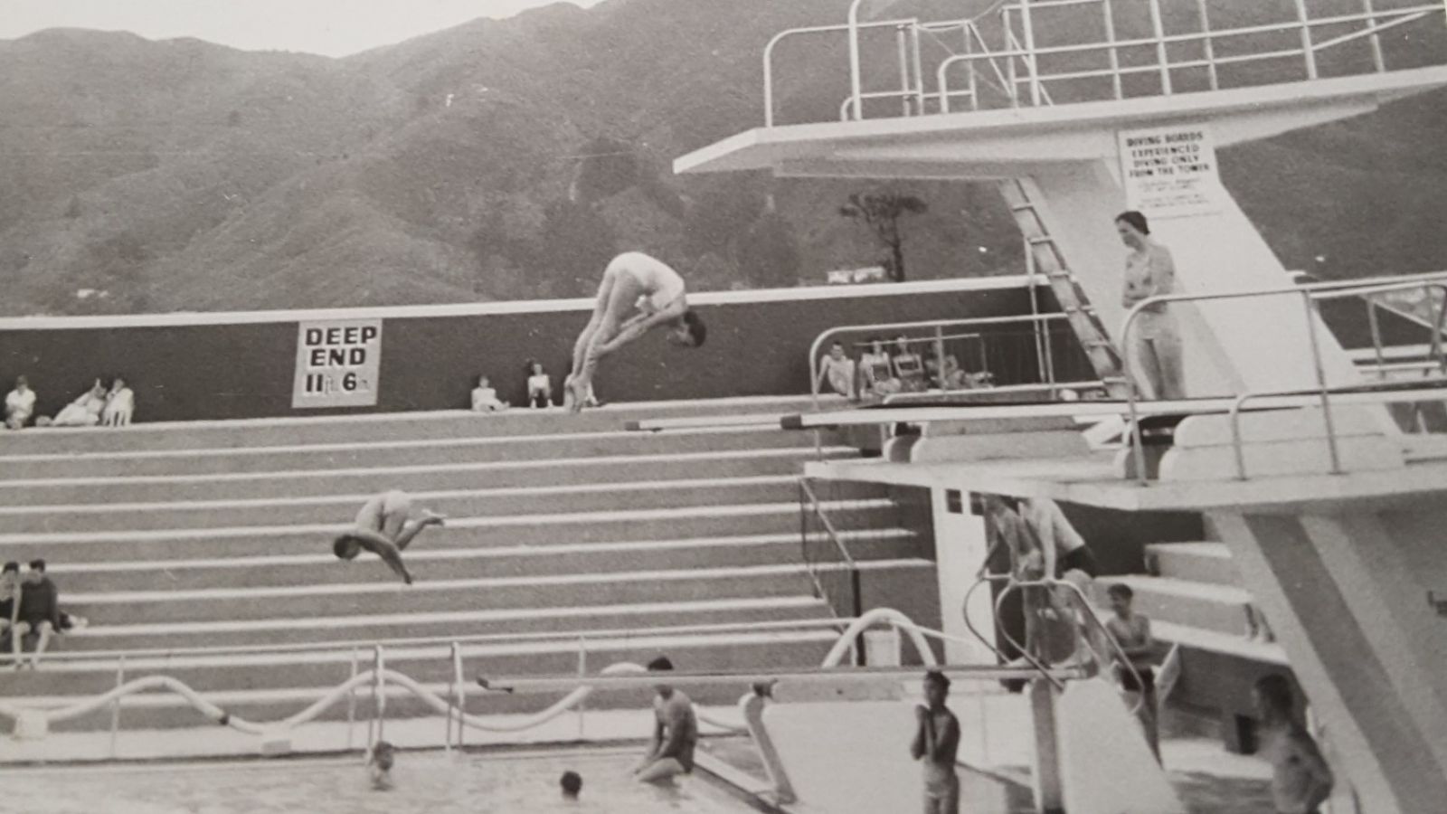 Black and white image of divers at Naenae Olympic Pool banner image